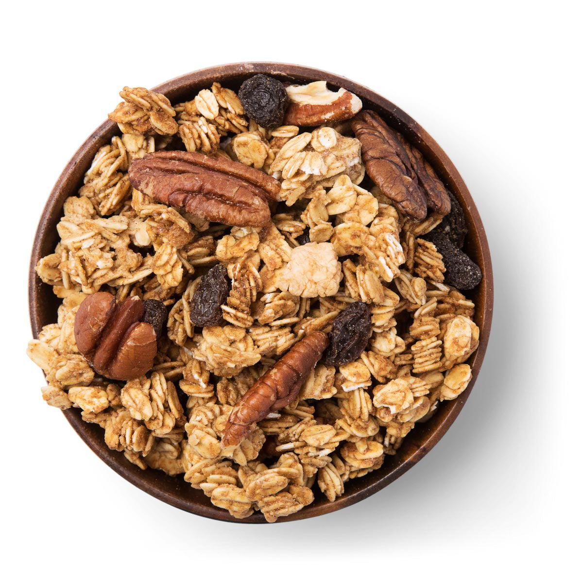 Wooden bowl filled with granola, nuts, and raisins on a white background