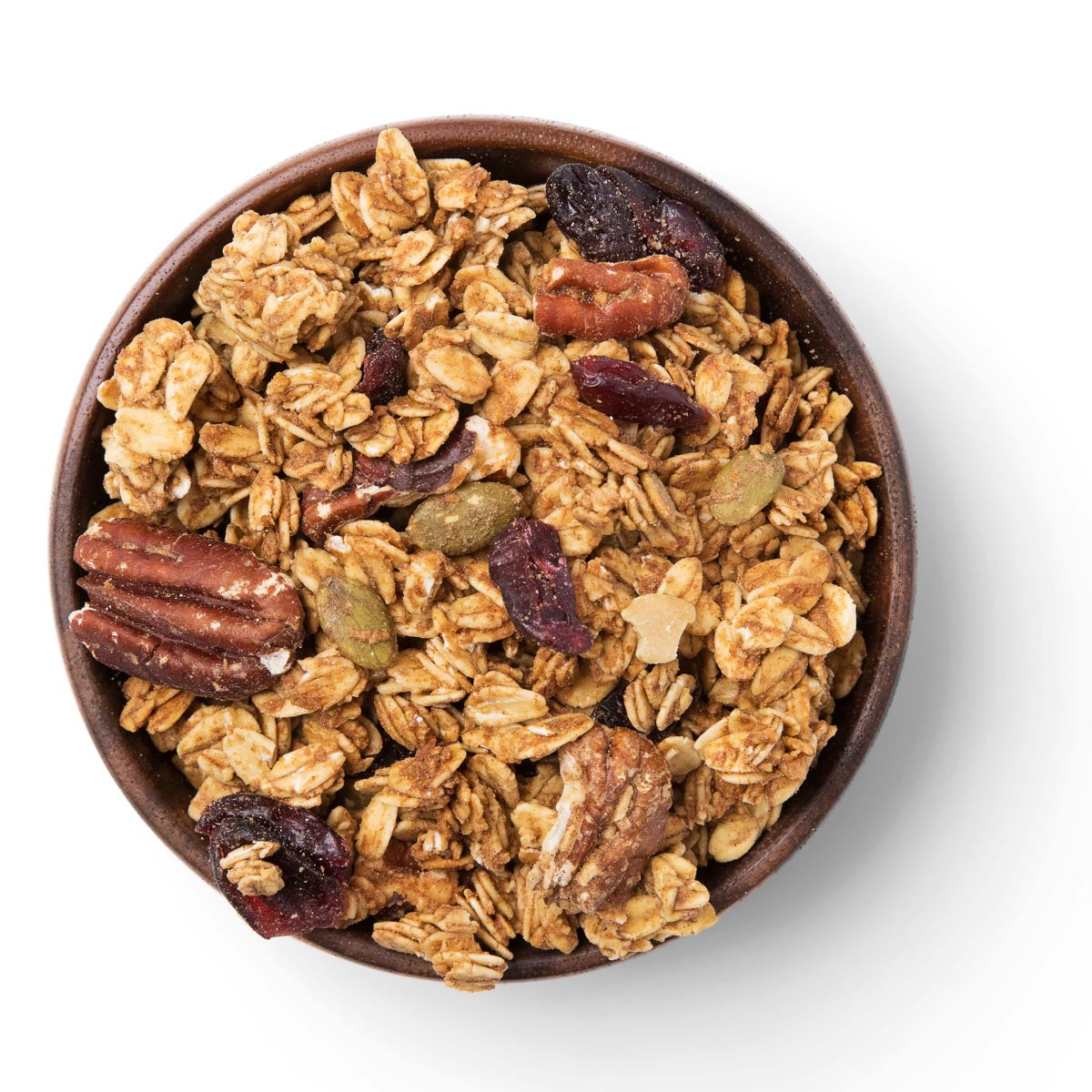 Bowl of granola with nuts and dried fruits on a white background