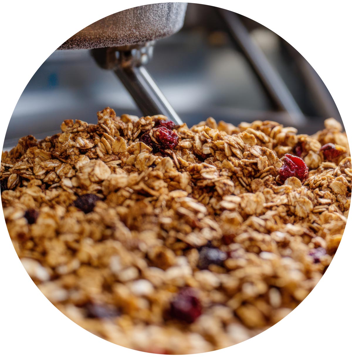 Close-up of granola with dried berries and a spoon in the background